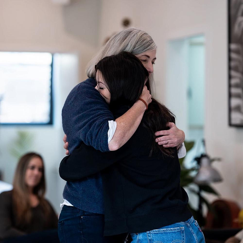 A mother and daughter hugging after taking part in an invitational drug/alcohol intervention organized and hosted by Certified Recovery Coach Michael Walsh and his team of Canadian sober coaches and interventionists