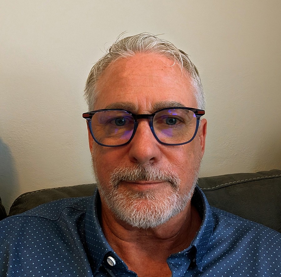 Compassionate and experienced recovery specialist, Mike Shea, standing confidently in a serene natural setting that reflects his love for nature and personal journey of transformation and healing